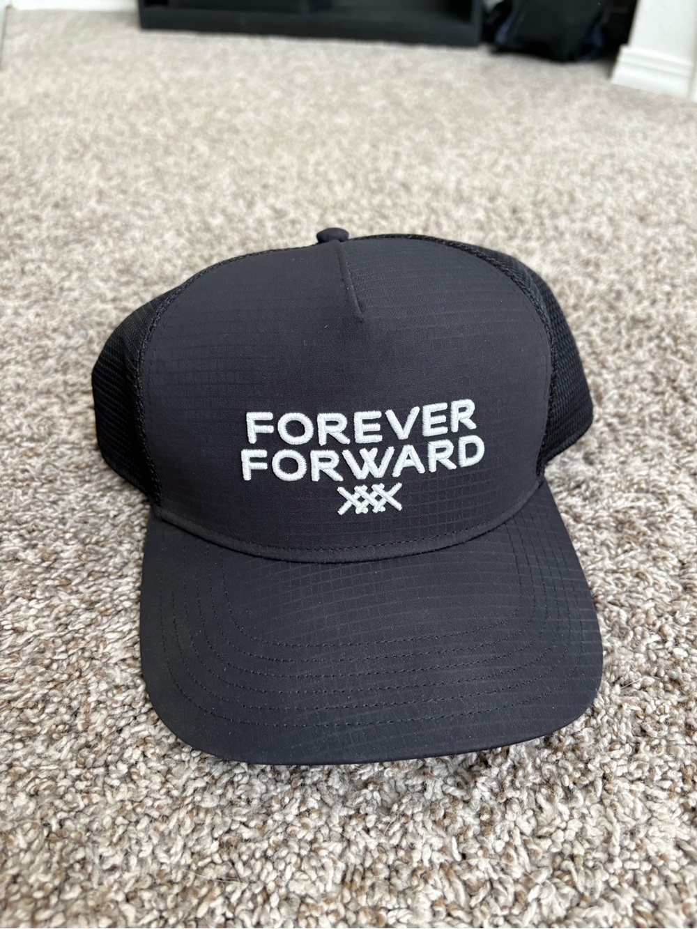 RHONE Black Trucker Hat with White Embroidered 'FOREVER FORWARD'
